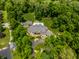 Stunning aerial view of an estate home with mature trees, large manicured lawn, and private pool at 4242 Watson Rd, Greenwood, IN 46143