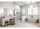 Spa-like bathroom features a soaking tub, glass shower, and a vanity with ample counter space at 4242 Watson Rd, Greenwood, IN 46143