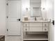 Elegant bathroom vanity with marble countertop, sleek faucet, decorative mirror, and stylish fixtures at 4242 Watson Rd, Greenwood, IN 46143