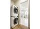 Modern bathroom is visible through laundry area featuring stacked washer/dryer at 4242 Watson Rd, Greenwood, IN 46143
