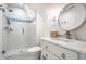 Well-lit bathroom with a modern glass shower, stylish vanity, round mirror, and tasteful finishes at 4242 Watson Rd, Greenwood, IN 46143