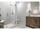 Modern bathroom featuring walk-in shower with tiled wall and floating vanity sink at 4242 Watson Rd, Greenwood, IN 46143