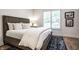 Bright bedroom features a queen bed with stylish black and white rug at 4242 Watson Rd, Greenwood, IN 46143