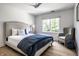 Inviting bedroom featuring a king bed with plush bedding, chair, and a window with scenic outdoor views at 4242 Watson Rd, Greenwood, IN 46143