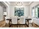 Elegant dining room with stylish chandelier, modern art, and large windows at 4242 Watson Rd, Greenwood, IN 46143