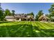 Large home exterior with manicured lawn, outdoor living spaces, and a cozy fire pit area, perfect for entertaining at 4242 Watson Rd, Greenwood, IN 46143