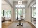 Bright foyer with hardwood floors, elegant light fixture, and view of the front yard at 4242 Watson Rd, Greenwood, IN 46143