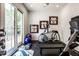 Home gym features various exercise equipment and large glass doors to bring in light at 4242 Watson Rd, Greenwood, IN 46143