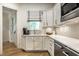 Well-lit kitchen boasts white cabinetry, stainless steel appliances, and a window over the sink at 4242 Watson Rd, Greenwood, IN 46143