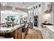 Open-concept kitchen with granite island, stainless steel appliances, and arched doorway at 4242 Watson Rd, Greenwood, IN 46143