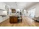 Open-concept kitchen with granite island, hardwood floors, and easy access to outdoor living space at 4242 Watson Rd, Greenwood, IN 46143