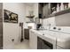 Modern laundry room with side-by-side washer and dryer, shelving, and stylish decor at 4242 Watson Rd, Greenwood, IN 46143