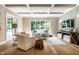 Bright living room features coffered ceiling, large window with backyard views, and hardwood floors at 4242 Watson Rd, Greenwood, IN 46143