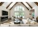 Stylish living room boasts fireplace, vaulted ceiling, and seamless indoor-outdoor transition at 4242 Watson Rd, Greenwood, IN 46143