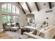 Inviting living room featuring high ceilings, exposed wood beams, and a wall of windows at 4242 Watson Rd, Greenwood, IN 46143