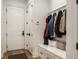 Well-organized mudroom with bench, storage, and coat hooks, providing a practical entry space at 4242 Watson Rd, Greenwood, IN 46143
