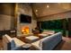Outdoor living space with a stone fireplace, bar area, and comfortable seating at 4242 Watson Rd, Greenwood, IN 46143