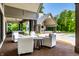 Covered patio with comfortable seating, offering a relaxing view of the pool and outdoor area at 4242 Watson Rd, Greenwood, IN 46143