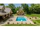Inviting pool area featuring an in-ground pool, diving board, and an outdoor fireplace at 4242 Watson Rd, Greenwood, IN 46143