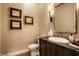 Powder room features decorative mirror and faucet, along with elegant wall art at 4242 Watson Rd, Greenwood, IN 46143
