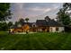 Spacious backyard with a well-manicured lawn, a fire pit, and outdoor entertaining space at 4242 Watson Rd, Greenwood, IN 46143