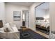 Bright sitting room leads into bedroom with a comfortable queen-sized bed at 4242 Watson Rd, Greenwood, IN 46143