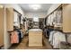 Spacious walk-in closet with custom shelving, hanging racks, and center island with drawers at 4242 Watson Rd, Greenwood, IN 46143