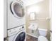 This cozy bathroom features a stacked washer and dryer, sink and toilet at 4316 London Ct, Anderson, IN 46013