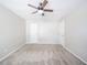 A simplistic bedroom features neutral walls, carpet, and a ceiling fan above at 4316 London Ct, Anderson, IN 46013
