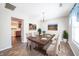 Elegant dining room with a wooden table, chairs, chandelier, and colorful artwork at 4316 London Ct, Anderson, IN 46013