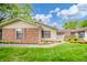 Charming single story home with well maintained lawn, garden and brick facade at 4316 London Ct, Anderson, IN 46013