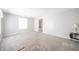 Bright and airy living room with neutral paint, plush carpet, and large window at 4316 London Ct, Anderson, IN 46013