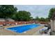 Inviting in-ground swimming pool with surrounding patio and relaxing lounge chairs, perfect for summer enjoyment at 4316 London Ct, Anderson, IN 46013