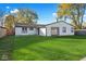 Well-maintained backyard with lush green grass and a classic white-sided home at 4457 Campbell Ave, Indianapolis, IN 46226