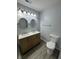 This bathroom features double sinks, new paint, and new floors at 4457 Campbell Ave, Indianapolis, IN 46226
