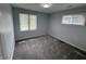 This bedroom has new paint, new carpet, and two windows at 4457 Campbell Ave, Indianapolis, IN 46226