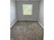 This bedroom has new paint, new carpet, and a window at 4457 Campbell Ave, Indianapolis, IN 46226