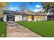 Charming single-story home with a well-manicured lawn and driveway leading to the garage at 4457 Campbell Ave, Indianapolis, IN 46226