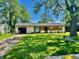 Charming single-story home with a well-manicured lawn, mature trees, and a welcoming front entrance at 4457 Campbell Ave, Indianapolis, IN 46226