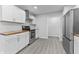 Modern kitchen with stainless steel appliances, white cabinets, and butcher block countertops at 4457 Campbell Ave, Indianapolis, IN 46226