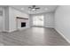 Unfurnished living room with a brick fireplace, gray walls, and modern vinyl plank flooring at 4457 Campbell Ave, Indianapolis, IN 46226