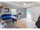 Spacious bedroom features hardwood floors, fan, work space, and access to the patio at 4482 Priscilla Ave, Indianapolis, IN 46226