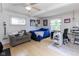 Bright bedroom with hardwood floors, fan, comfortable seating, and work space at 4482 Priscilla Ave, Indianapolis, IN 46226