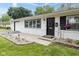 Inviting front porch with brick accent and black door, enhancing the home's curb appeal at 4482 Priscilla Ave, Indianapolis, IN 46226