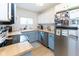 Charming kitchen features blue lower cabinets, stainless appliances, light countertops, and wood floors at 4482 Priscilla Ave, Indianapolis, IN 46226