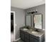 Bathroom featuring double sink with granite countertop, black fixtures, framed mirrors and modern lighting at 450 Columbia Ct, Greenwood, IN 46142