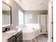 Bathroom featuring a large soaking tub and gray walls at 450 Columbia Ct, Greenwood, IN 46142
