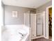 Bathroom features a soaking tub and glass door shower at 450 Columbia Ct, Greenwood, IN 46142