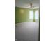 This carpeted bedroom has a ceiling fan and large window at 450 Columbia Ct, Greenwood, IN 46142