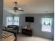 Spacious bedroom featuring an accent chair, tv on a console and two windows at 450 Columbia Ct, Greenwood, IN 46142
